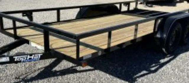 A Top Hat utility trailer on a wood deck at Cope's Trailers