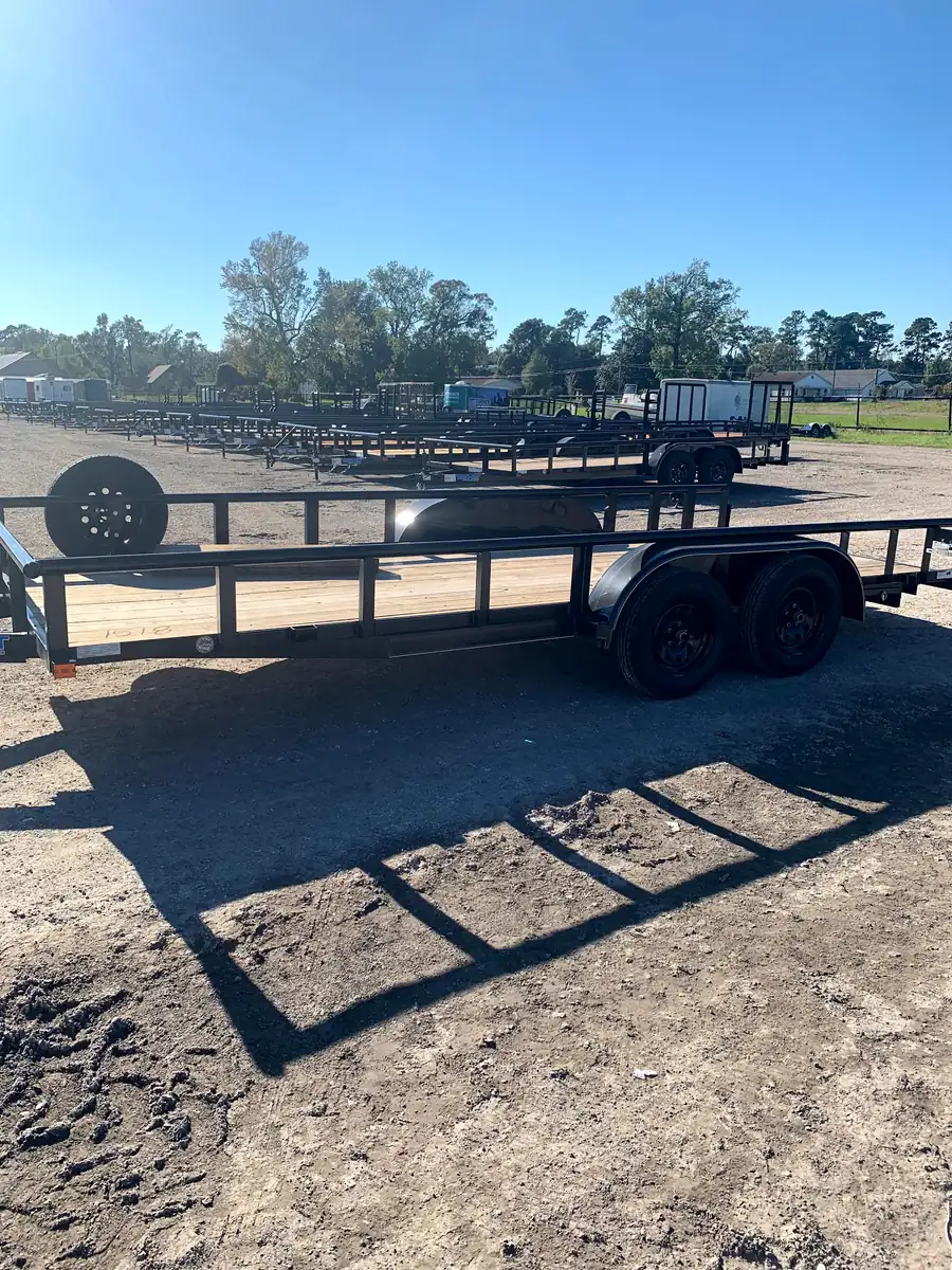 Rows of black utility trailers on the Cope's Trailers lot in Rose City, Texas